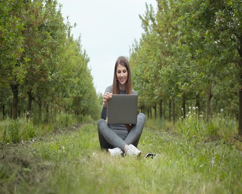 Woman working on laptop looking comfortable